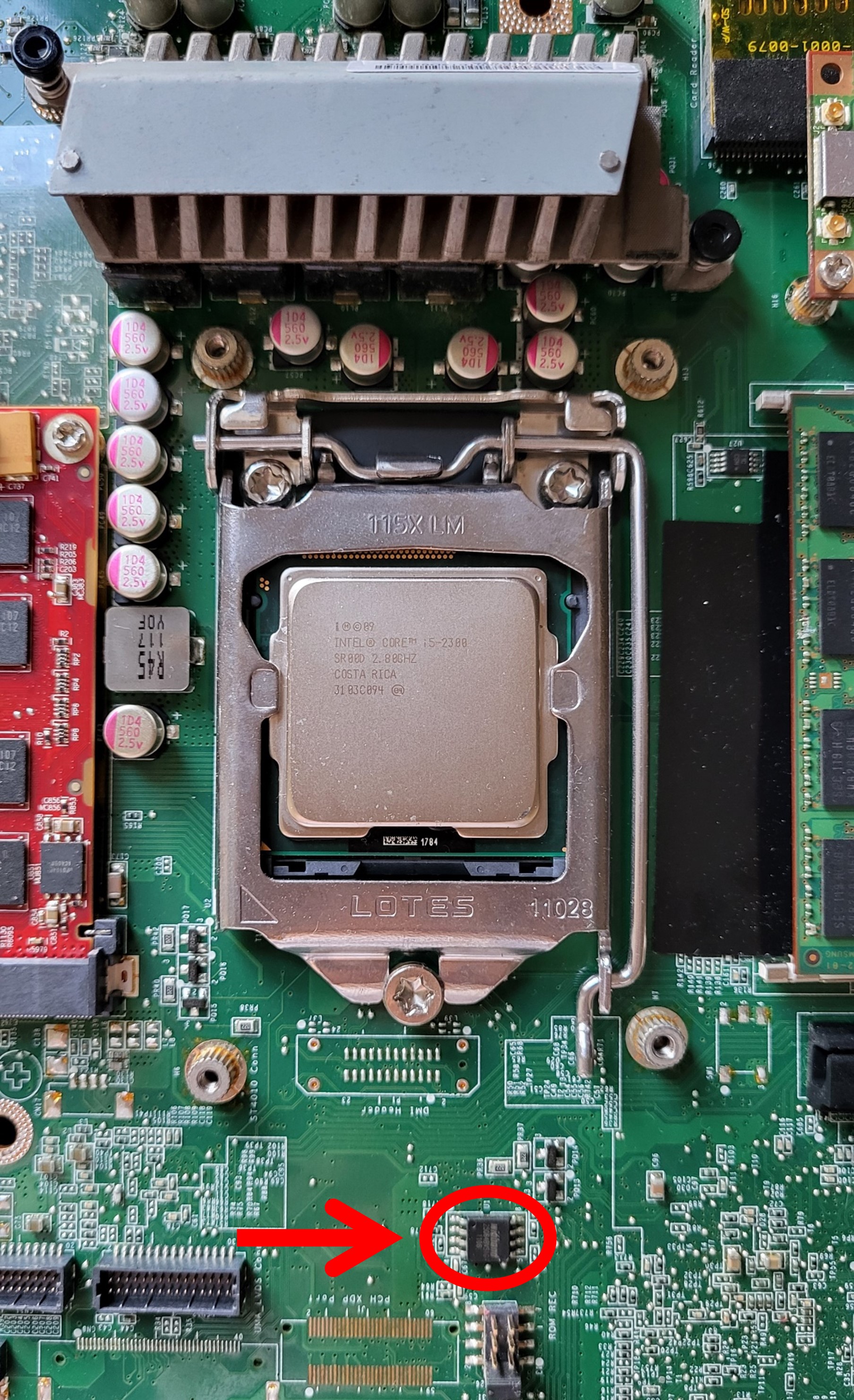 The tiny, black, square ROM chip is located to the south of the CPU chipset and is encircled in the picture in red.